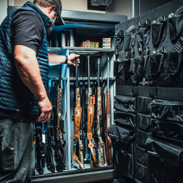 Man grabbing rifle from safe